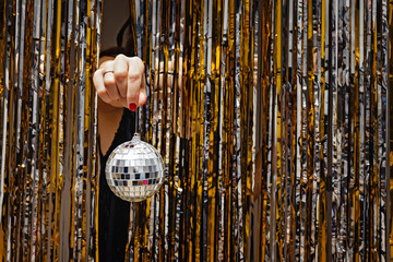 Woman's hand holding decorative disco ball