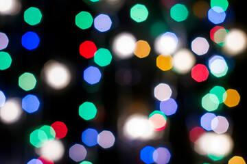 Fototapeta premium multicolored festive lights on a black background screensaver backdrop