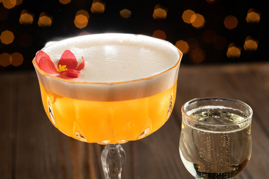 Cocktail on a wood background. Cold citrus alcoholic drink with Aperol, passion fruit syrup and proseco served with vodka
