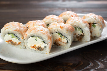 Traditional Japanese sushi with shrimp, eel, cream cheese, cucumber and red caviar. Japanese kitchen. Sushi set