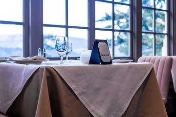 In the restaurant, reserved table by the window with a sign