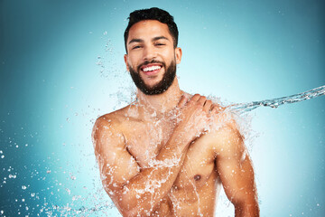 Man, skincare and water splash shower in studio for wellness, health and grooming in blue...