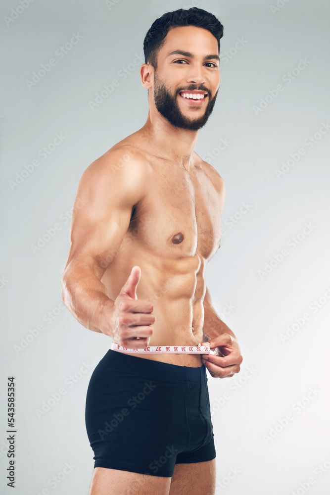 Canvas Prints body, waist and thumbs up with a man model in studio on a gray background to promote weightloss or e