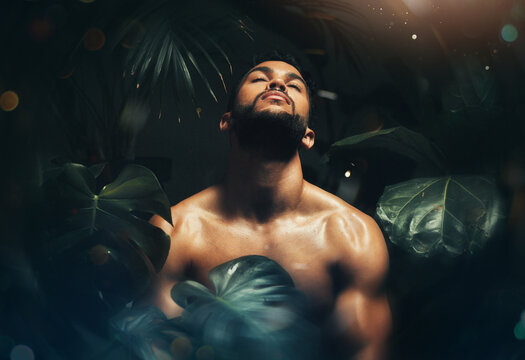 Beauty, man and body in jungle leaf nature for natural skincare cosmetics advertising. Tropical, monstera and handsome black model thinking of sustainable, health and wellness cosmetic.