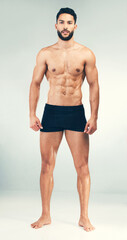 Portrait, bodybuilder and healthy man for fitness, wellness or workout being toned for flex with studio background. Muscular male, health or athlete muscle with endurance, power or body care exercise