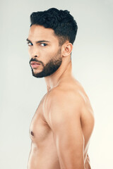 Fototapeta premium Fitness, body wellness and portrait man pose for skincare, body care and health on white background in studio. Exercise, bodybuilding and profile of young male with serious face, muscles and strong