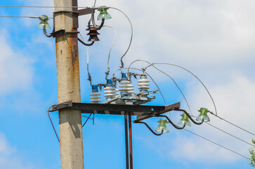 electric pole with wires on a blue sky background