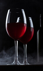 Glasses with red wine and bottle silhouette