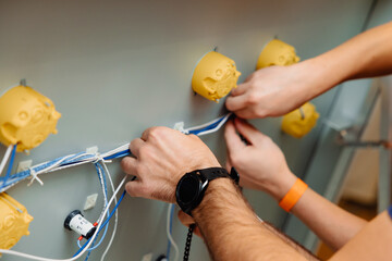 Electrician works cable checking energy