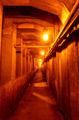Pedestrian zone of an underground tunnel illuminated by light bulbs