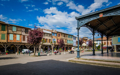 The covered market hall and the half timbered medieval houses on the main square of Mirepoix, in the South of France (Ariege)