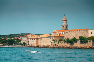 Fototapeta na wymiar Panoramic view of the old town of Krk in Croatia, cathedral tower and seascape in background
