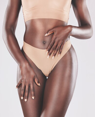 Body, hands and beauty with a model black woman in studio on a gray background wearing underwear....