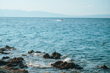 Alone Boat in clear blue Mediterranean sea. Summer Vacation photo. Edit space.
