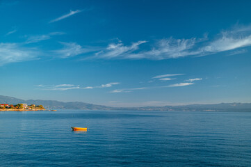 Obraz premium Alone Boat in clear blue Mediterranean sea. Summer Vacation photo. Edit space.