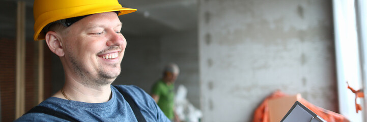 Smiling builder holding clipboard and write down needed work material for renovation