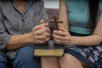 Two Christian people are praying to encourage and support together.