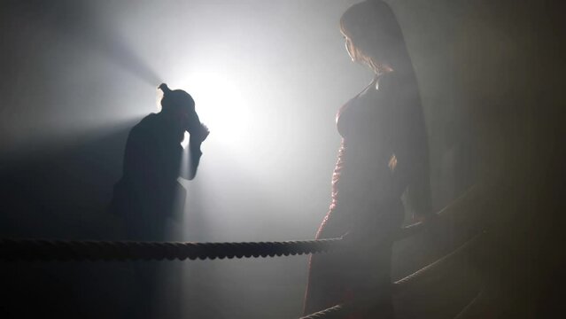 masculine man and feminine woman on boxing ring, concept of relationship and seduction
