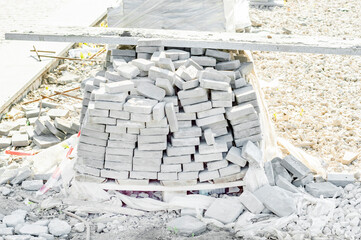 bricks or paving slabs are placed on pallets and wrapped in plastic wrap. horizontal photo.