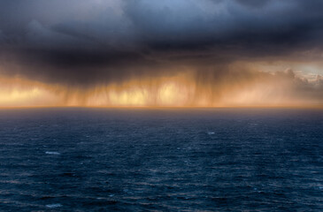 sunset over the sea with rain clouds