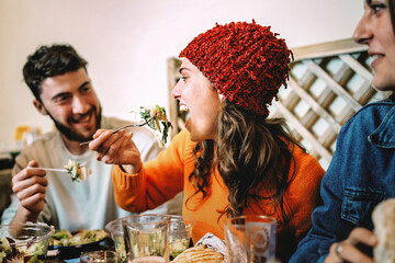 Young Friends Enjoying Food and Conversation in a Cozy Restaurant