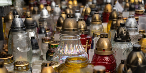Cemetery grave candle glass lanterns. All Saints' Day, Feast of All Souls. Commemoration of All the Faithful Departed and the Day of the Dead.