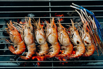 River prawns or giant freshwater prawns are roasted on sieve with stove.