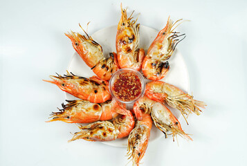 Top view of Thai grilled prawns (shrimps) in the shell in plastic plate served with Thai style...