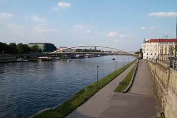 Vistula River (Wisła) in Krakow, Poland. Vistulan Boulevards with Father Bernatek’s pedestrian...