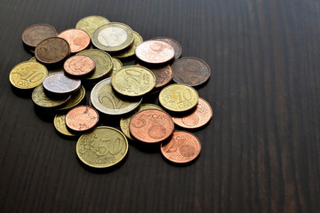 Euro cent coins on wood table.  Copy space is on the right side. 