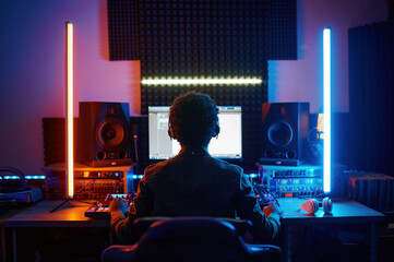 A music producer working in recording studio - obrazy, fototapety, plakaty
