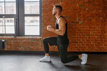 Muscular, sportive man practicing squats