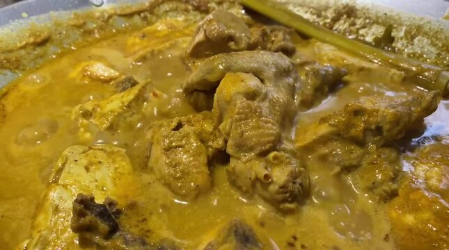 cooking chicken and tofu with coconut milk curry