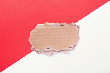 empty space for text made of cardboard on a red and white background close-up