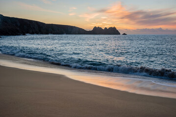 Majestic sunrise landscape at Porthcurno beach in Cornwall England with stunning colours and atmosphere