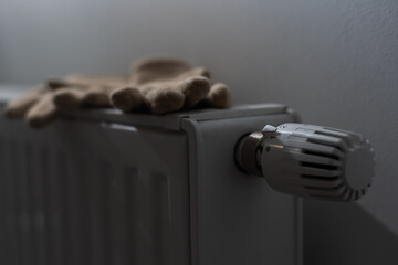 Warm gloves on the radiator. Heating season concept.