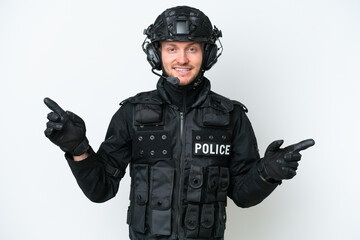 SWAT man over isolated white background pointing finger to the laterals and happy