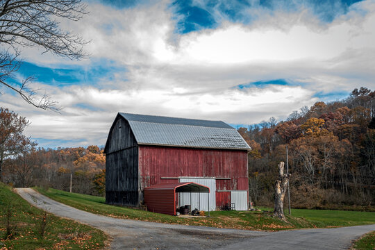 Old red barn at rural crossroads