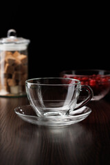 Glass tea cup with saucer. Selective focus, close-up.
