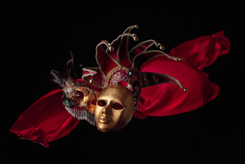 Old carnival masks with flutters red cloth.