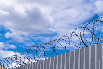 Sharp steel wire fence. Barded wire fence protection.