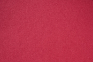 Fototapeta premium Closeup photo of cardboard sheet surface in magenta red color. Unicolor background.