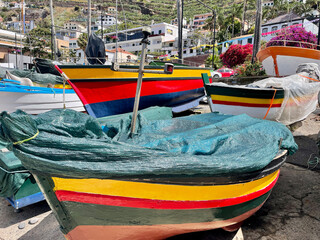 Colorful fishing boats at the port of a small town on Madeira island in Portugal