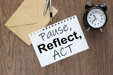 pause, reflect, act concept - text on white page. on the business table