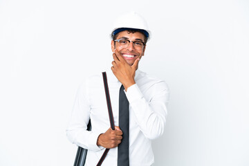 Architect brazilian man with helmet and holding blueprints happy and smiling
