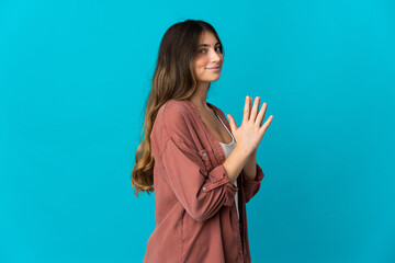 Young caucasian woman isolated on blue background scheming something