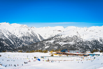 Fototapeta na wymiar People, families, skiers and snowboarders relaxing and having fun in winter at Soldeu ski lifts cross centre, Grandvalira, Andorra, Pyrenees Mountains