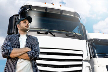 Truck driver standing in front of trucks