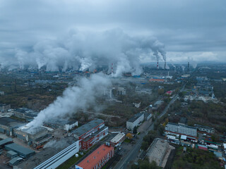 Fototapeta na wymiar Environmental pollution. Oil and gas industrial zone. Emissions from the chimneys of an industrial enterprise. Equipment for oil refining. Aerial photography. Bird's-eye view. Climate change.
