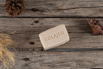 natural collagen soaps made with donkey milk stil life photo. on wooden background and soap, soap with collagen written on it